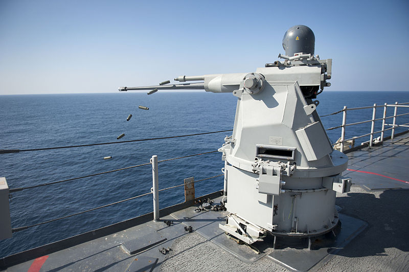 800px-US_Navy_111231-N-KS651-967_A_Mk_38_MOD_2_25mm_machine_gun_system_aboard_the_amphibious_dock_landing_ship_USS_Pearl_Harbor_%28LSD_52%29_ejects_casings_d.jpg